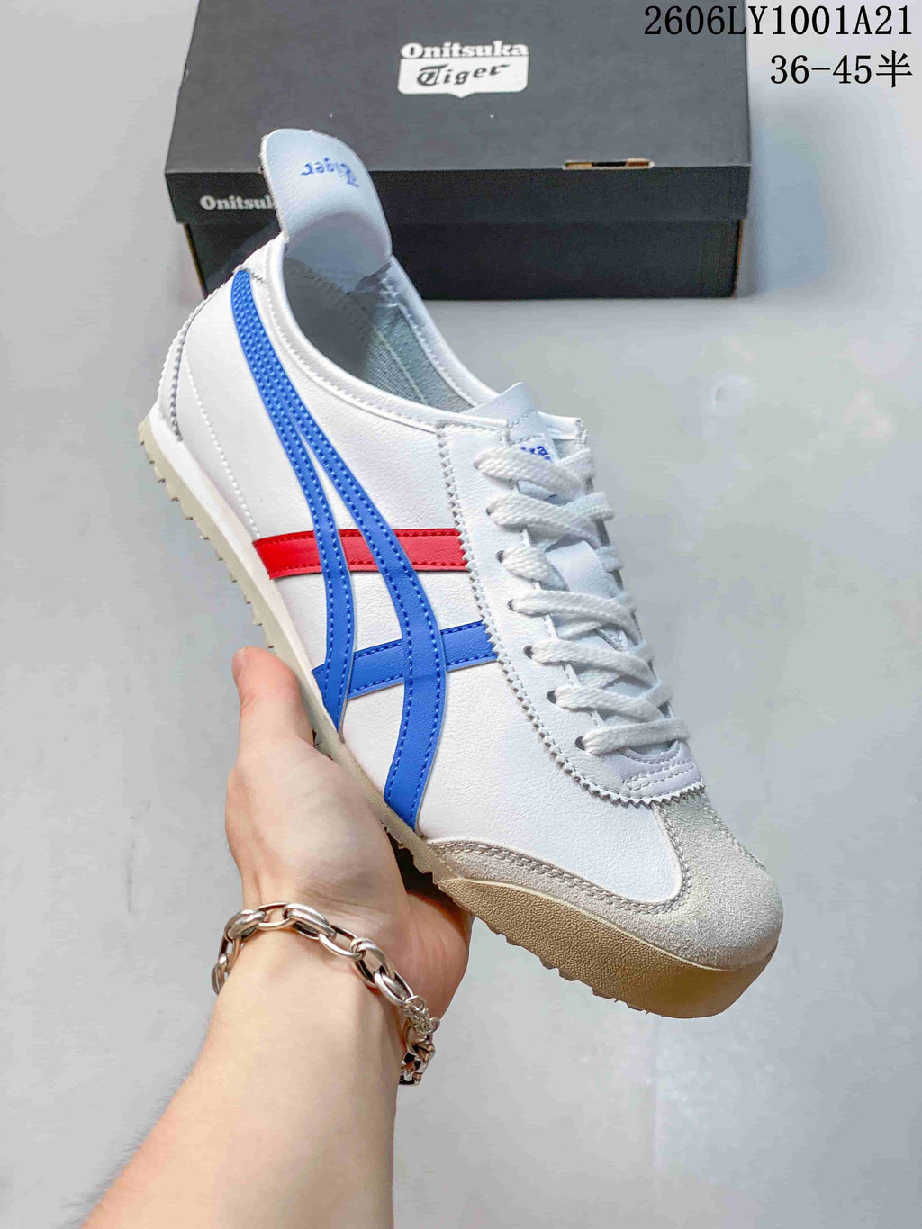 Angled side view of the Mexico 66 sneaker in white, blue, and red