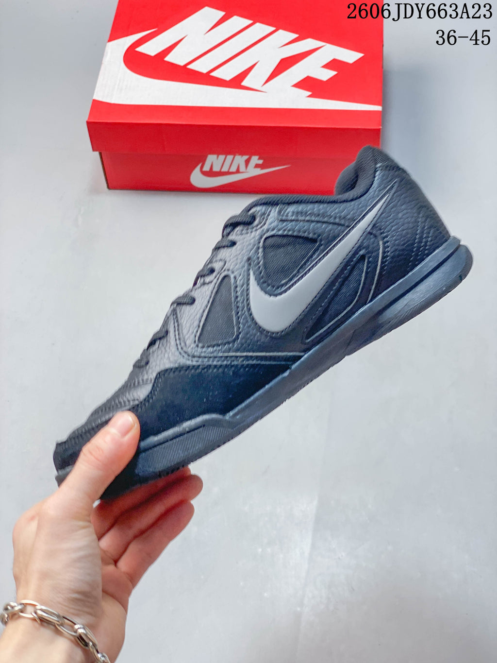 Side view of a dark gray Nike Gato sneaker with a light-colored Swoosh