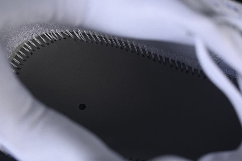 Close-up view inside the shoe, showing its dark footbed and stitched edge