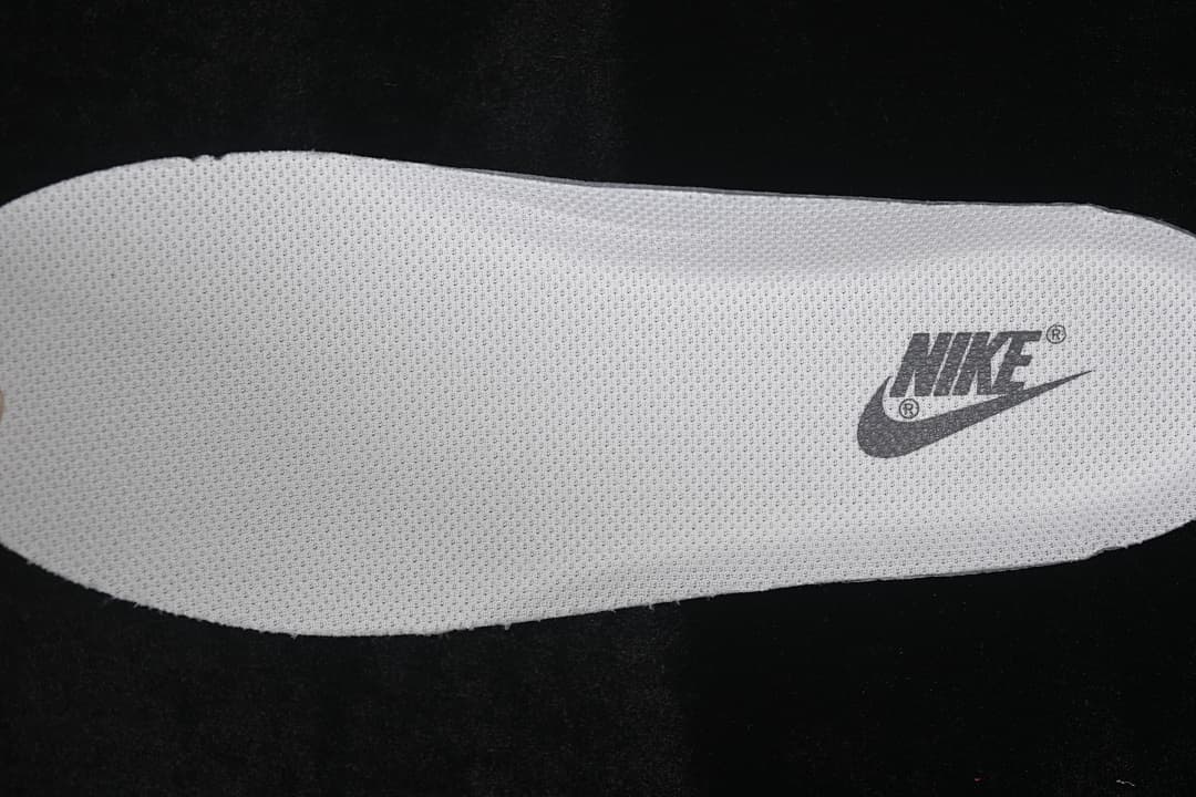 Close-up of a light-colored insole with a visible Nike logo