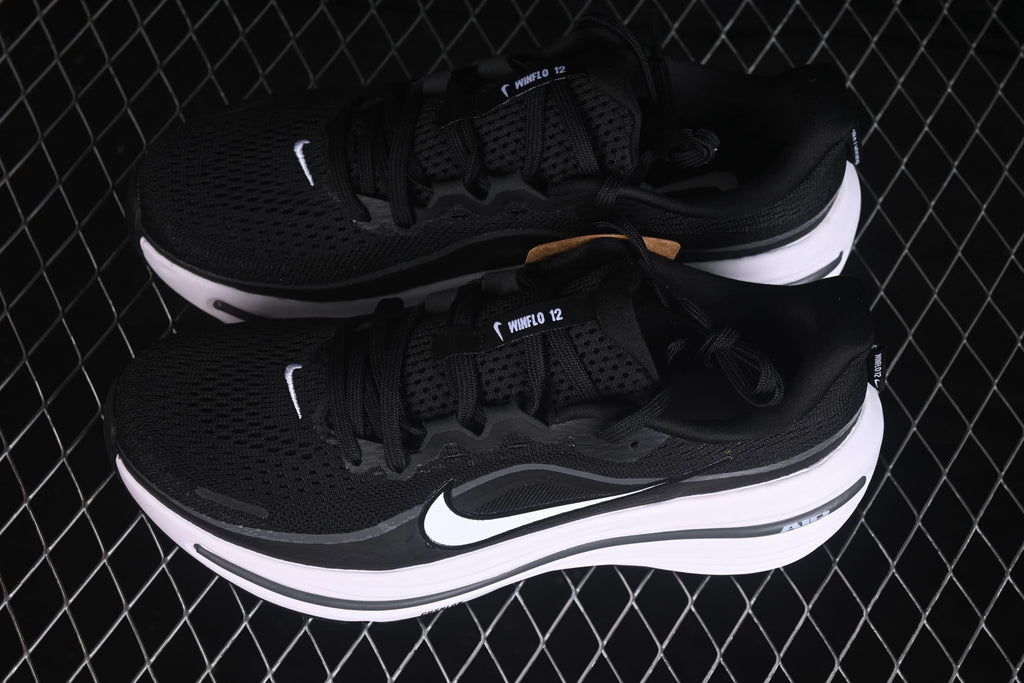 Angled view of the pair of black and white Nike Zoom Winflo 12 sneakers with visible side swooshes.