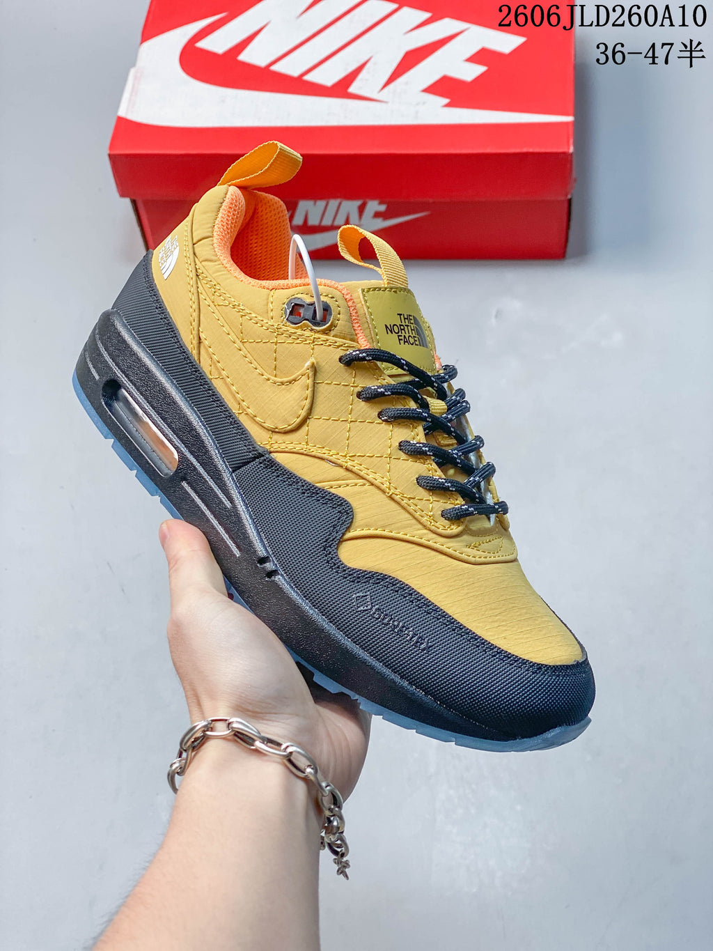 Angled side view of the yellow and dark sneaker