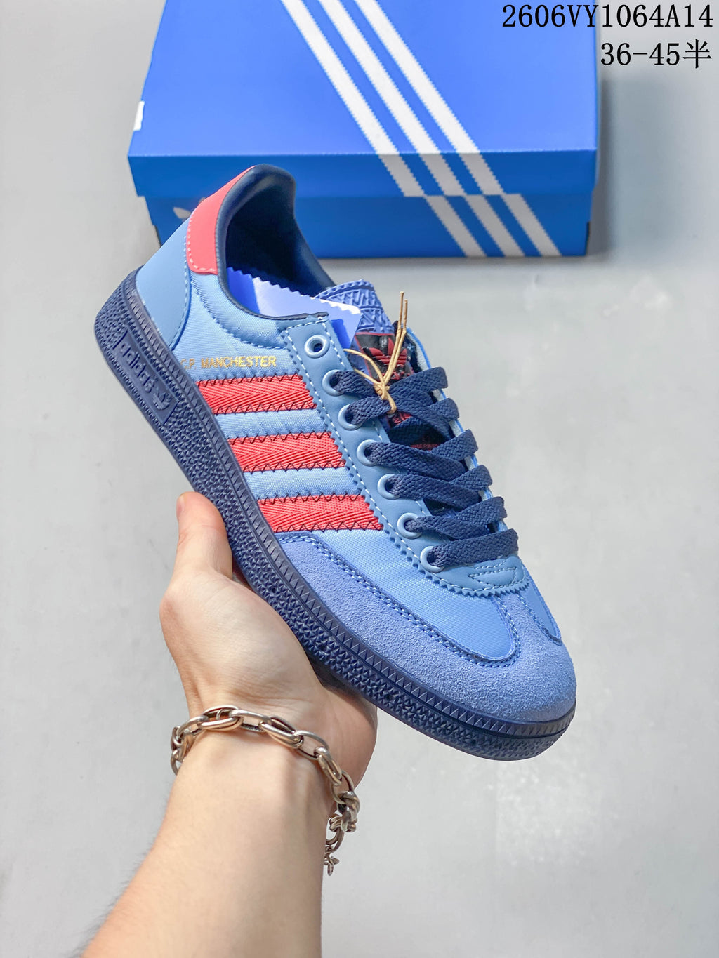 Angled side view of the sneaker with red stripes and dark blue sole