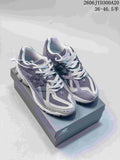 Pair of grey New Balance 1906 sneakers on a shoebox
