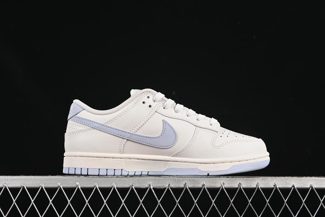 Side profile of the sneaker highlighting the light blue Swoosh