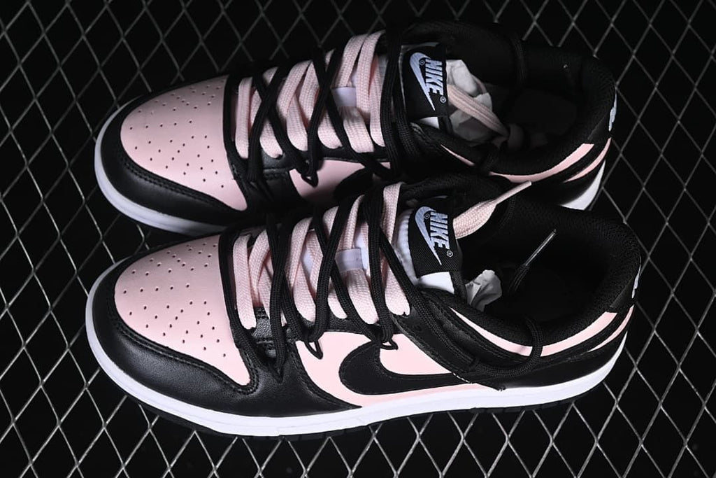 Pair of black and pale pink low-top sneakers viewed from above