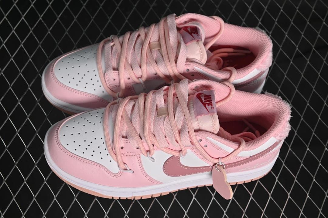 Pair of pink and white low-top sneakers shown from above and the side.