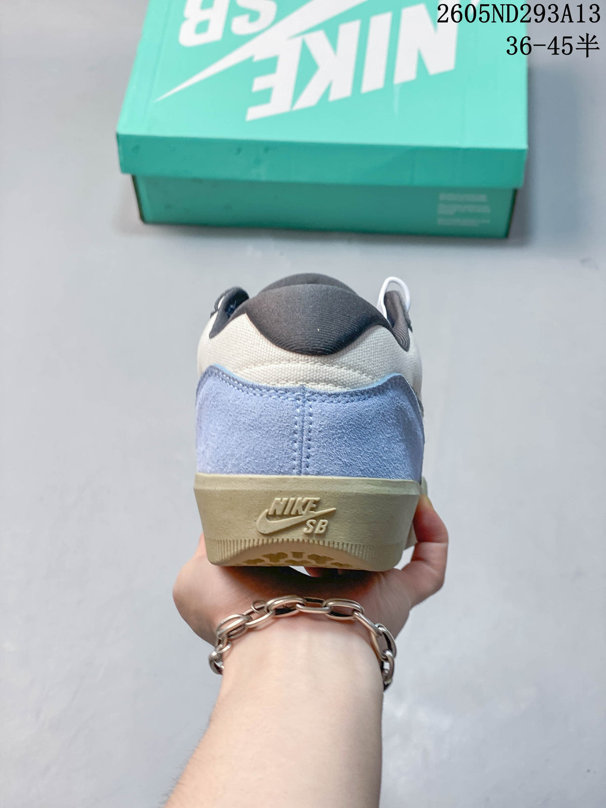 Rear view showing light blue heel panels and the gum-colored sole.
