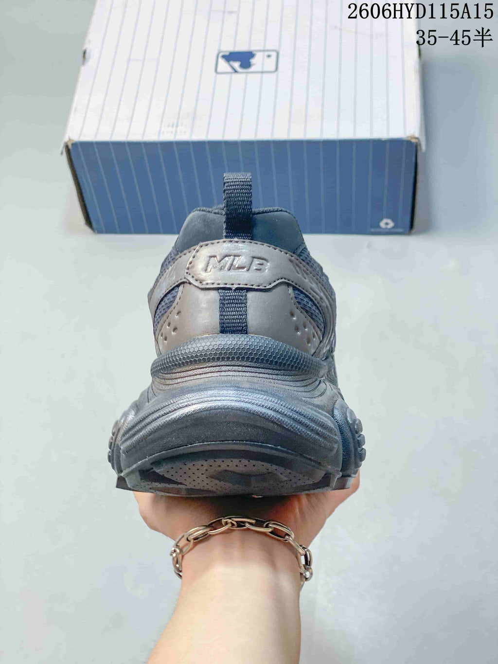 Rear view of a silver-gray MLB sneaker showing the heel and chunky outsole