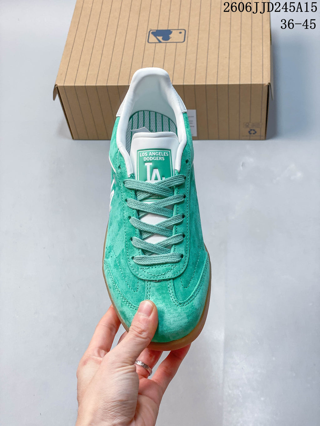 Top view showing the teal laces, white detailing, and Dodgers tongue graphic.