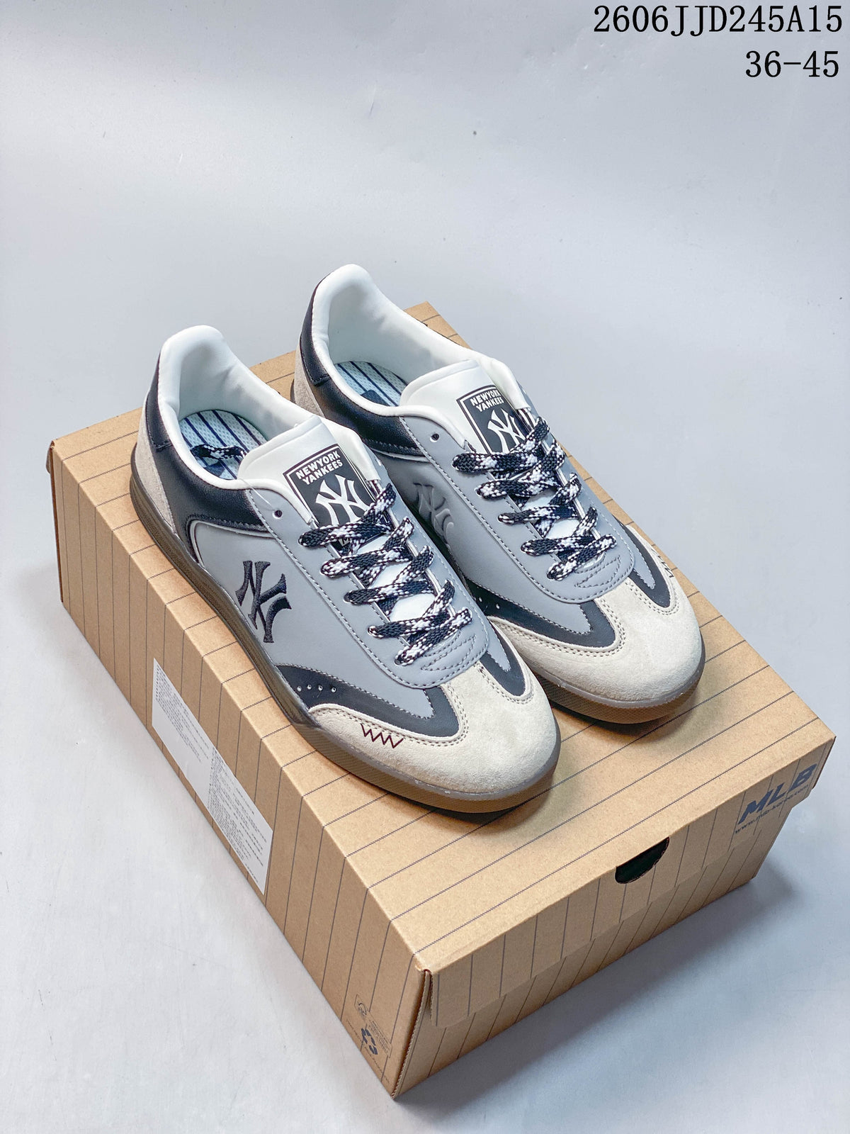 Pair of gray, navy, and off-white MLB team graphic low-top sneakers on a box