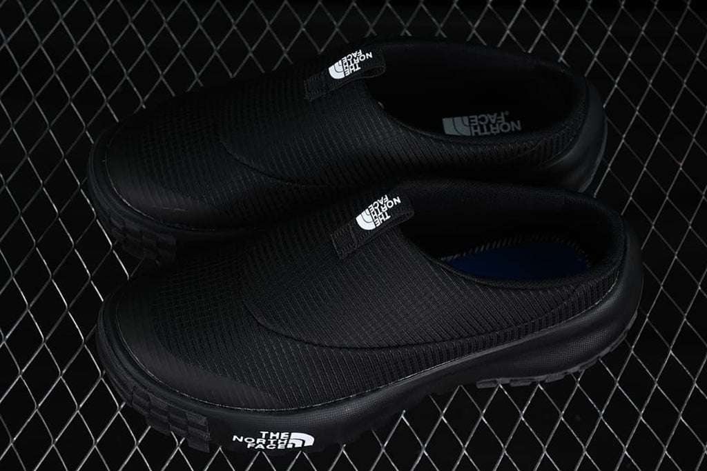 Pair of black slip-on mules shown from above