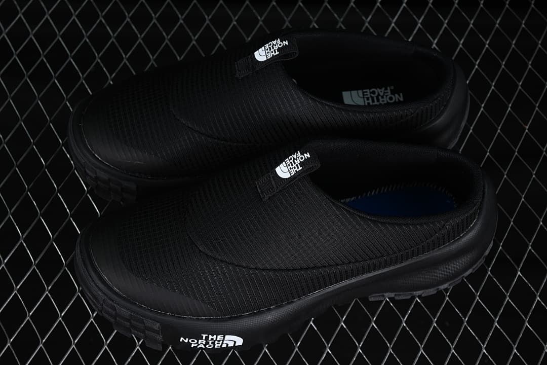 Pair of black slip-on mules shown from above