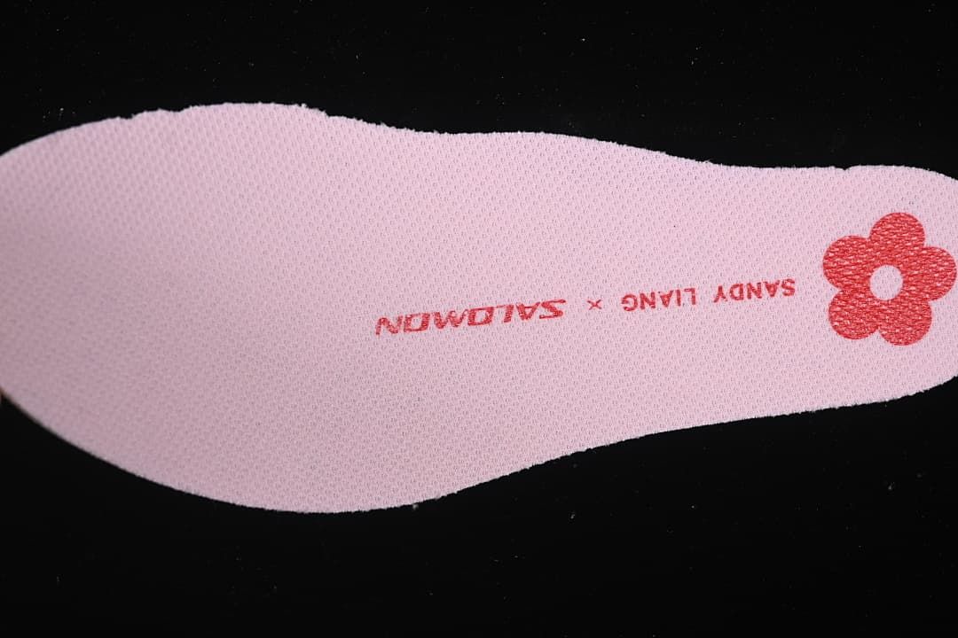 Close-up of a pink insole with Sandy Liang lettering and flower graphic