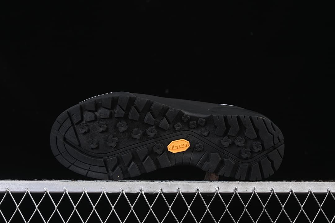 Underside of the shoe showing the lugged tread and Vibram mark.