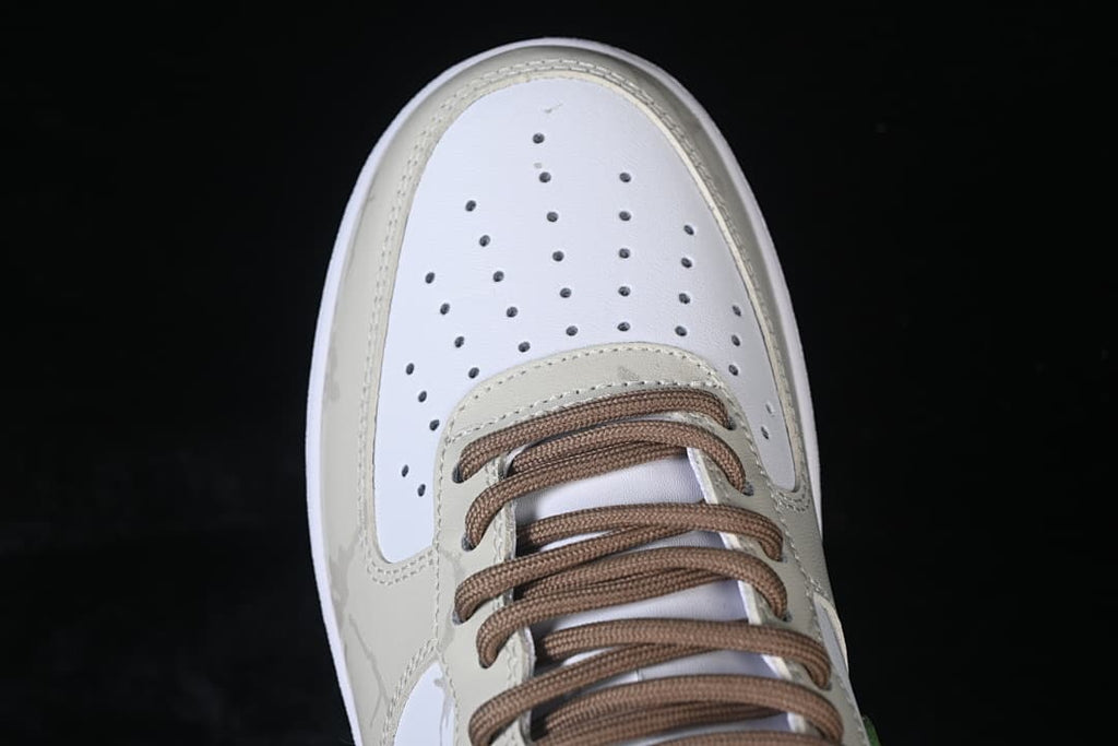 Top-down close-up of the perforated toe and brown laces