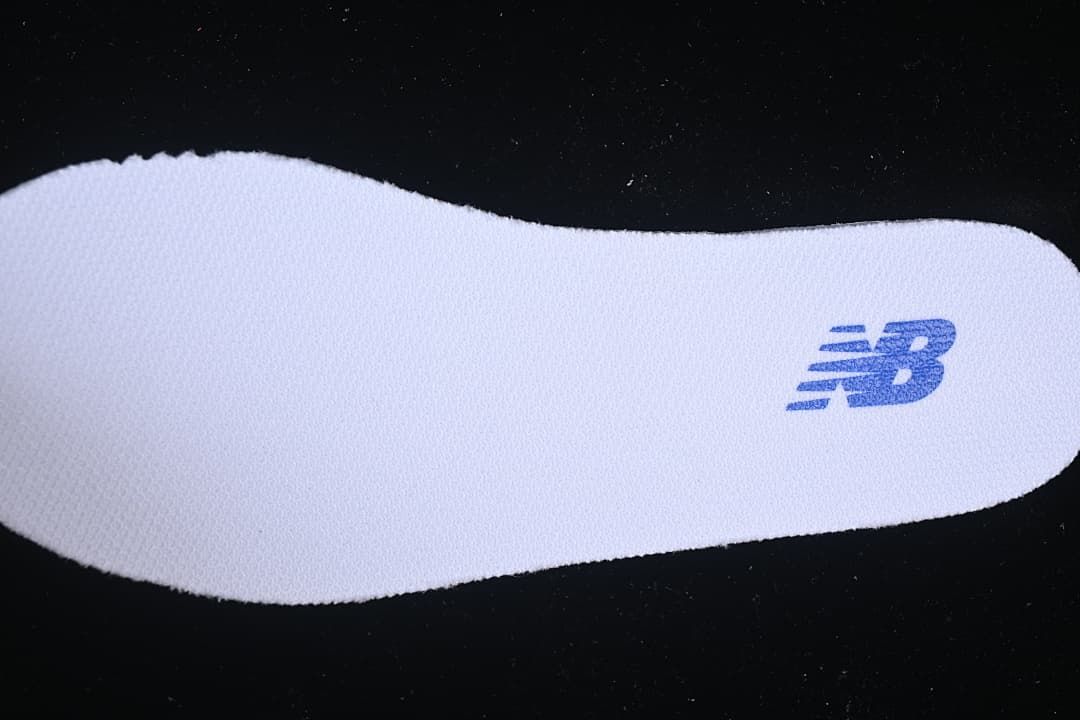 White insole with a blue New Balance logo.