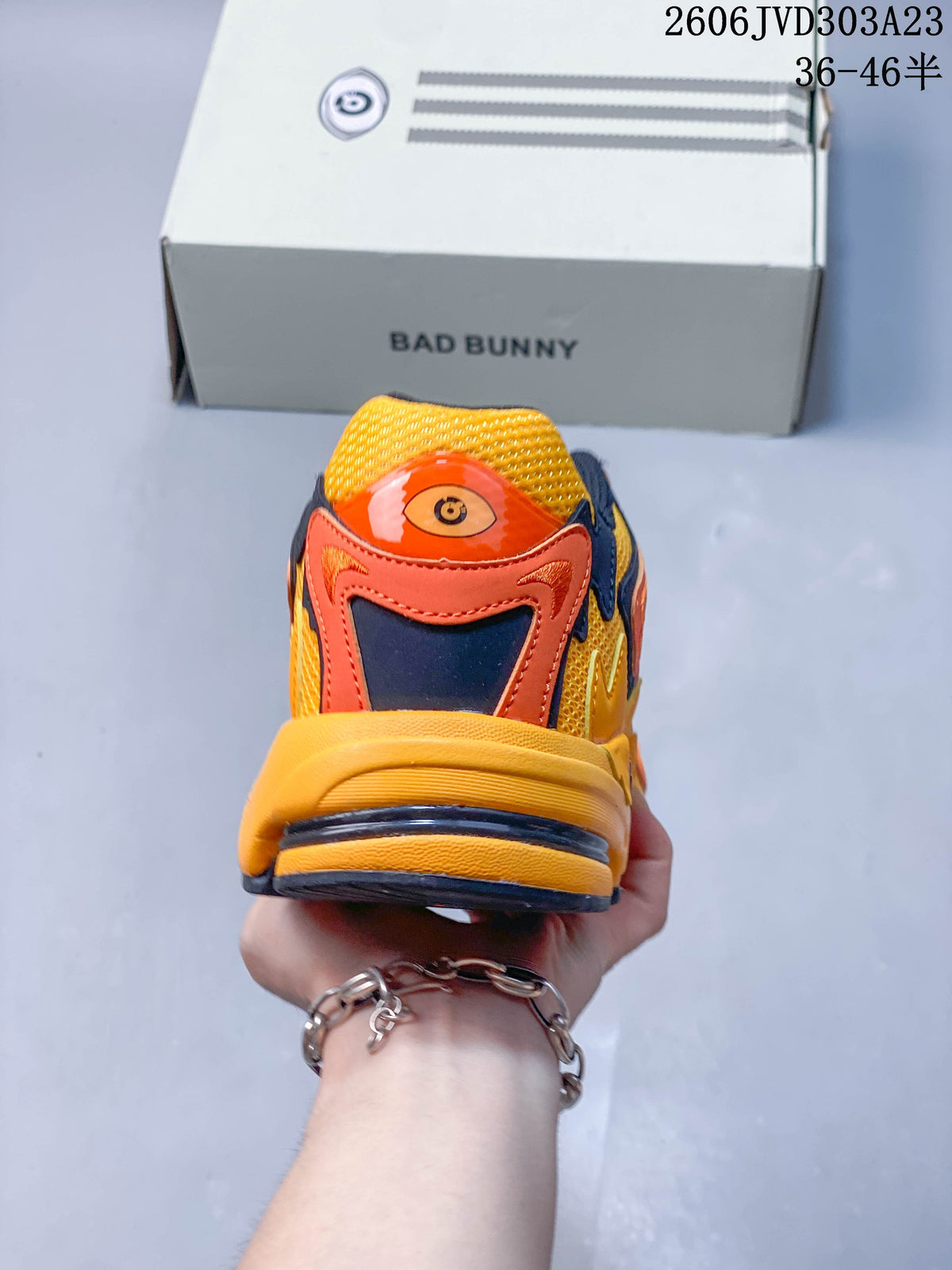 Rear view showing the layered heel design and yellow-orange color scheme