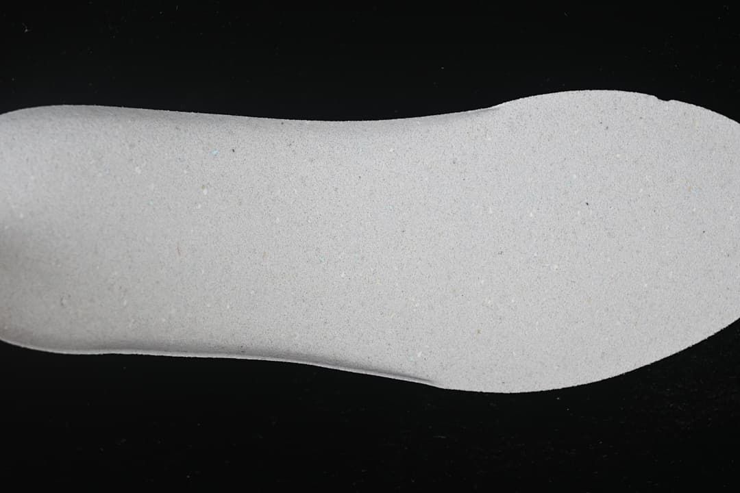 Close-up view of the shoe's light-colored insole.