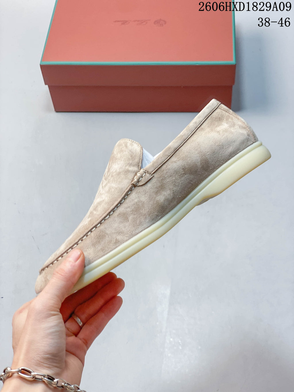 Side profile of a beige slip-on loafer with a pale sole