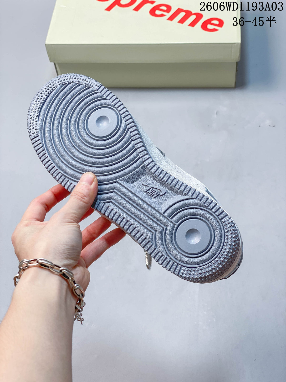 Underside view showing the sneaker's textured grey outsole