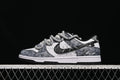 Side view of a grey, black, and white Nike SB Dunk Low sneaker with thick grey laces and “Angeles” heel embroidery