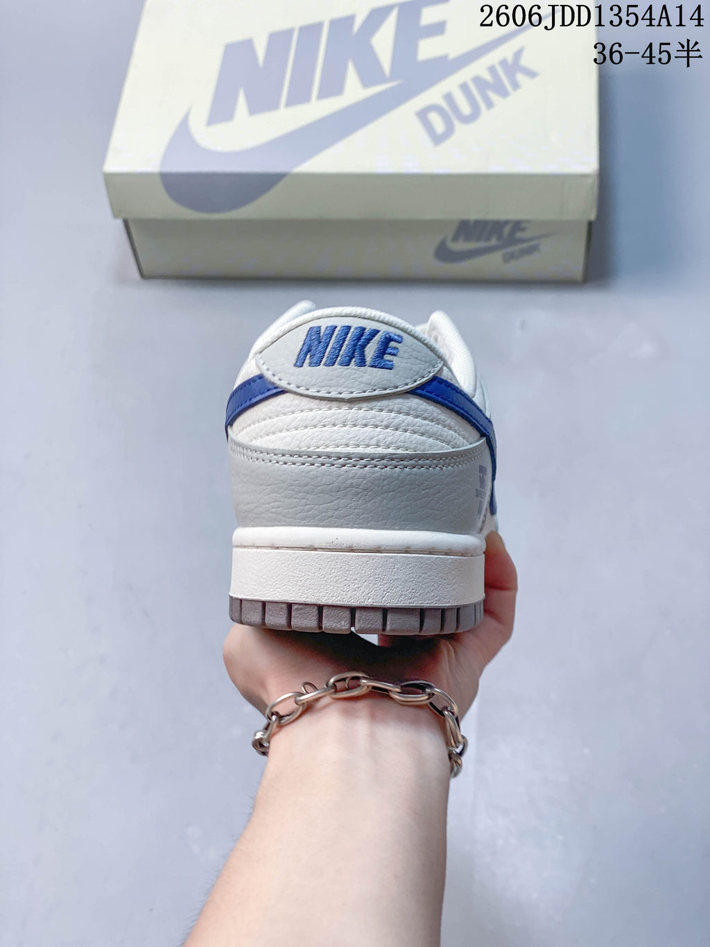 Rear view showing blue heel trim and embroidered Nike lettering