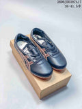 Pair of dark navy and brown low-top lace-up sneakers displayed on a branded box