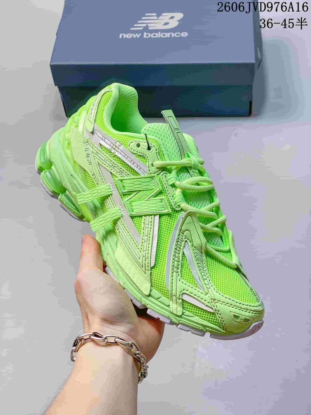 Close angled view of the lime-green New Balance sneaker showing layered side panels