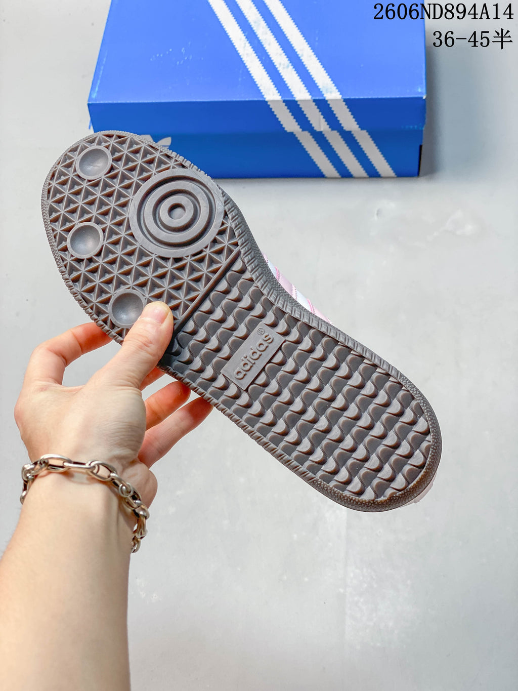 Close-up of the patterned dark gum-colored outsole on an adidas Samba OG sneaker.