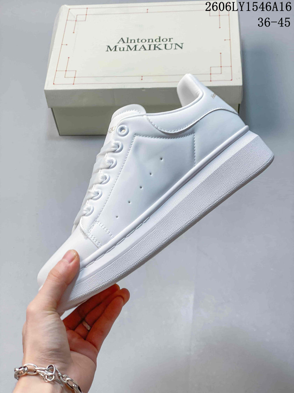 Side view of a white low-top sneaker with perforated panels and a thick sole.