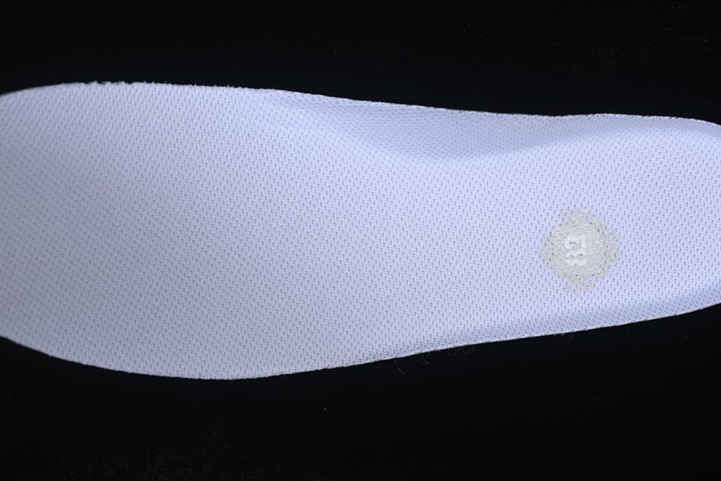 Close-up of a white insole with a small size marking.