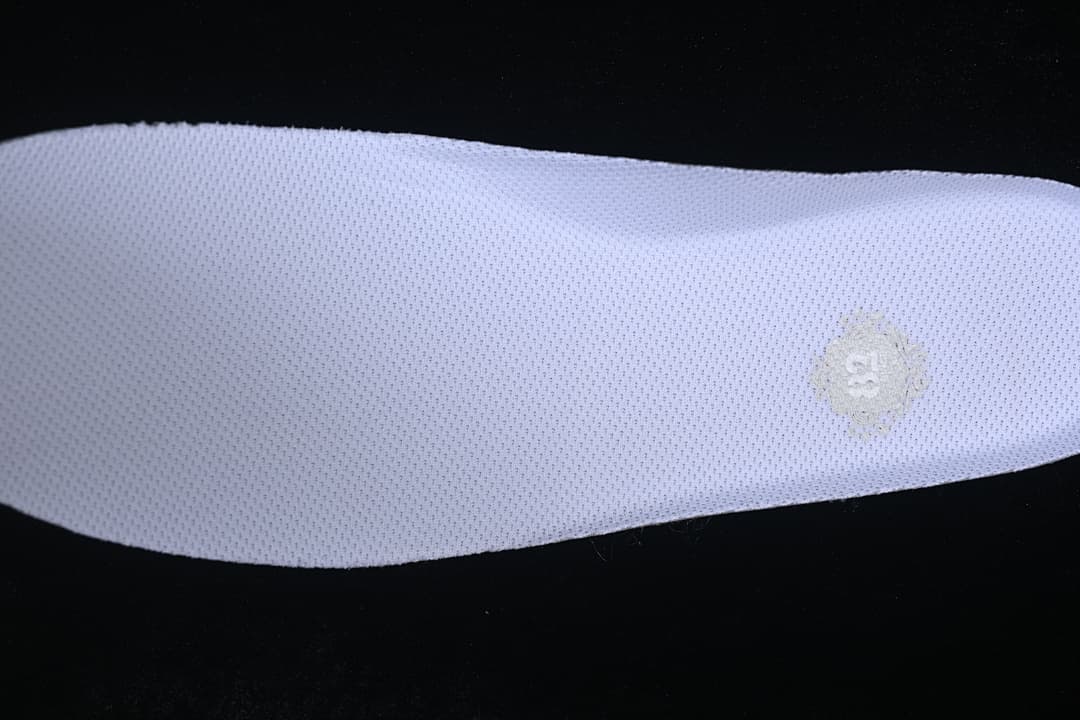 Close-up of a white insole with a small size marking.