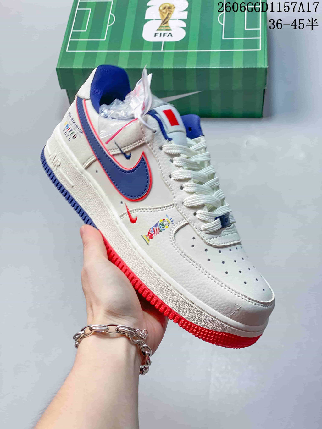 Close-up of a white sneaker with blue and red accents and a perforated toe