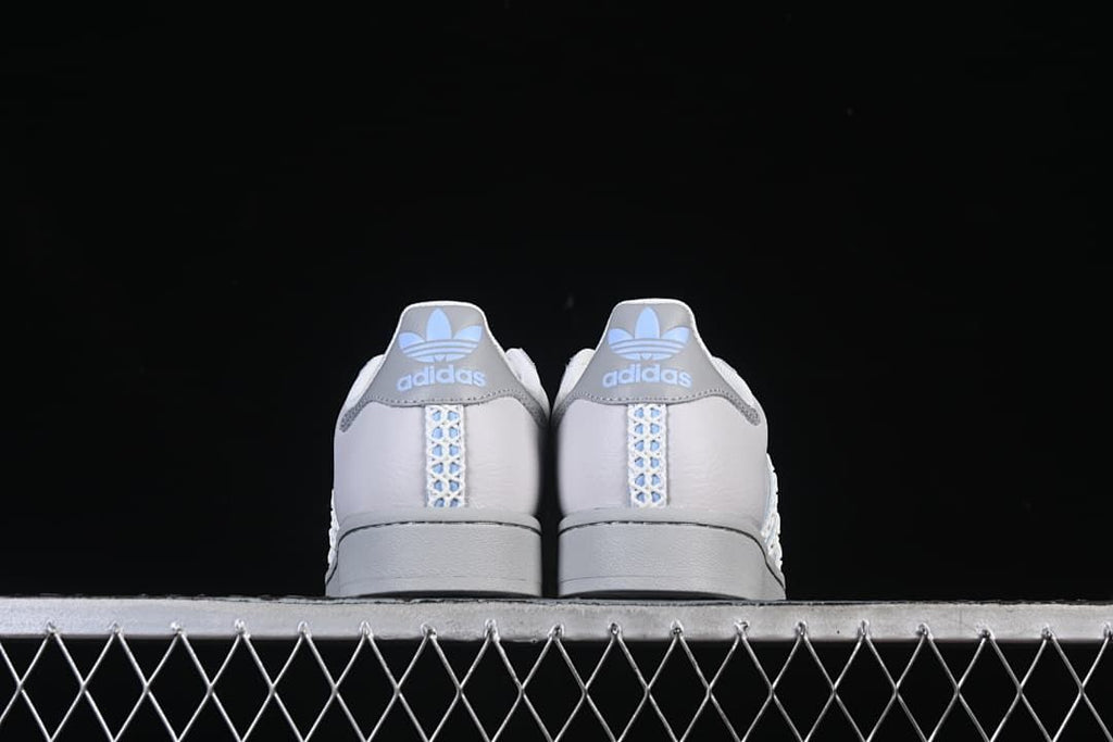 Rear view of the pair showing grey heel tabs and patterned center stripes.