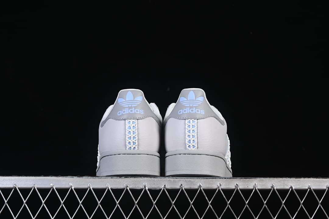 Rear view of the pair showing grey heel tabs and patterned center stripes.