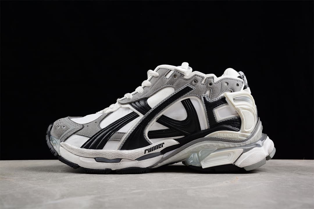 Side view of grey, white, and black Balenciaga Runner sneakers