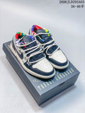 Pair of white and navy low-top Jordan sneakers with colorful lining, shown on a graphic shoebox