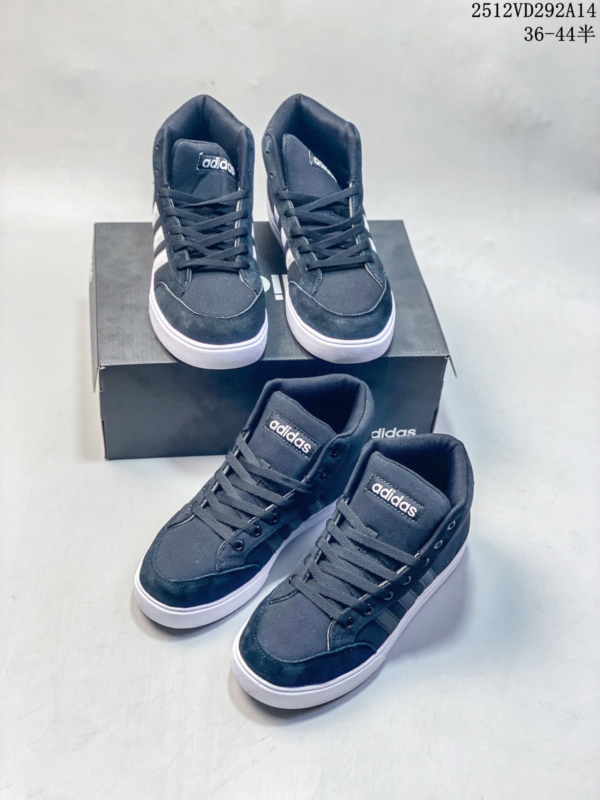 Four dark Adidas high-top sneakers arranged on and beside a shoebox.
