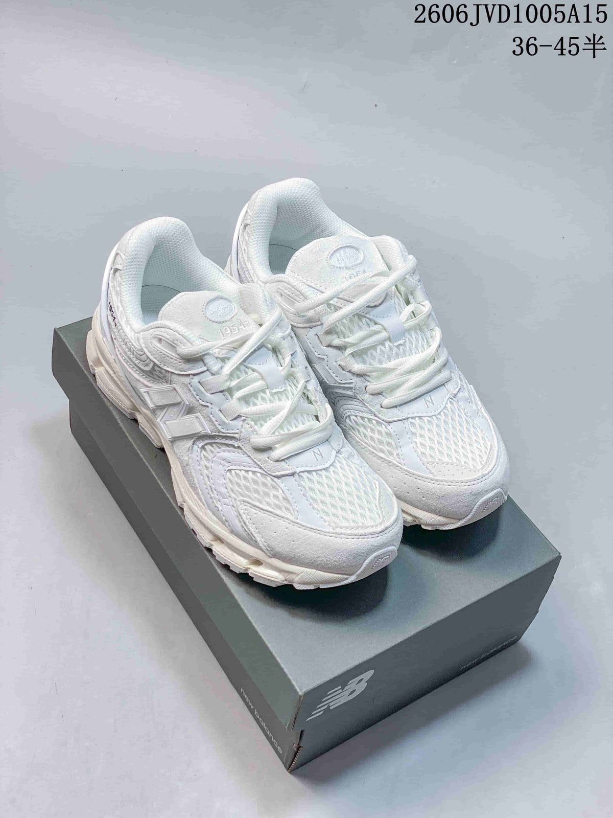 White New Balance 1954R sneakers shown from above on a shoe box