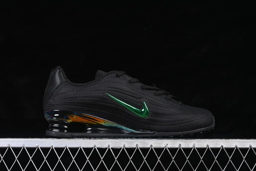 Side profile of the black sneaker with green Swoosh and iridescent heel accent.