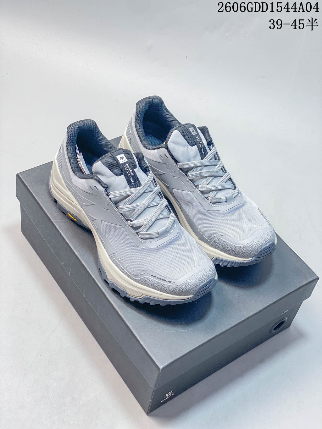 Pair of light grey KAILAS low-top hiking shoes on a shoebox.