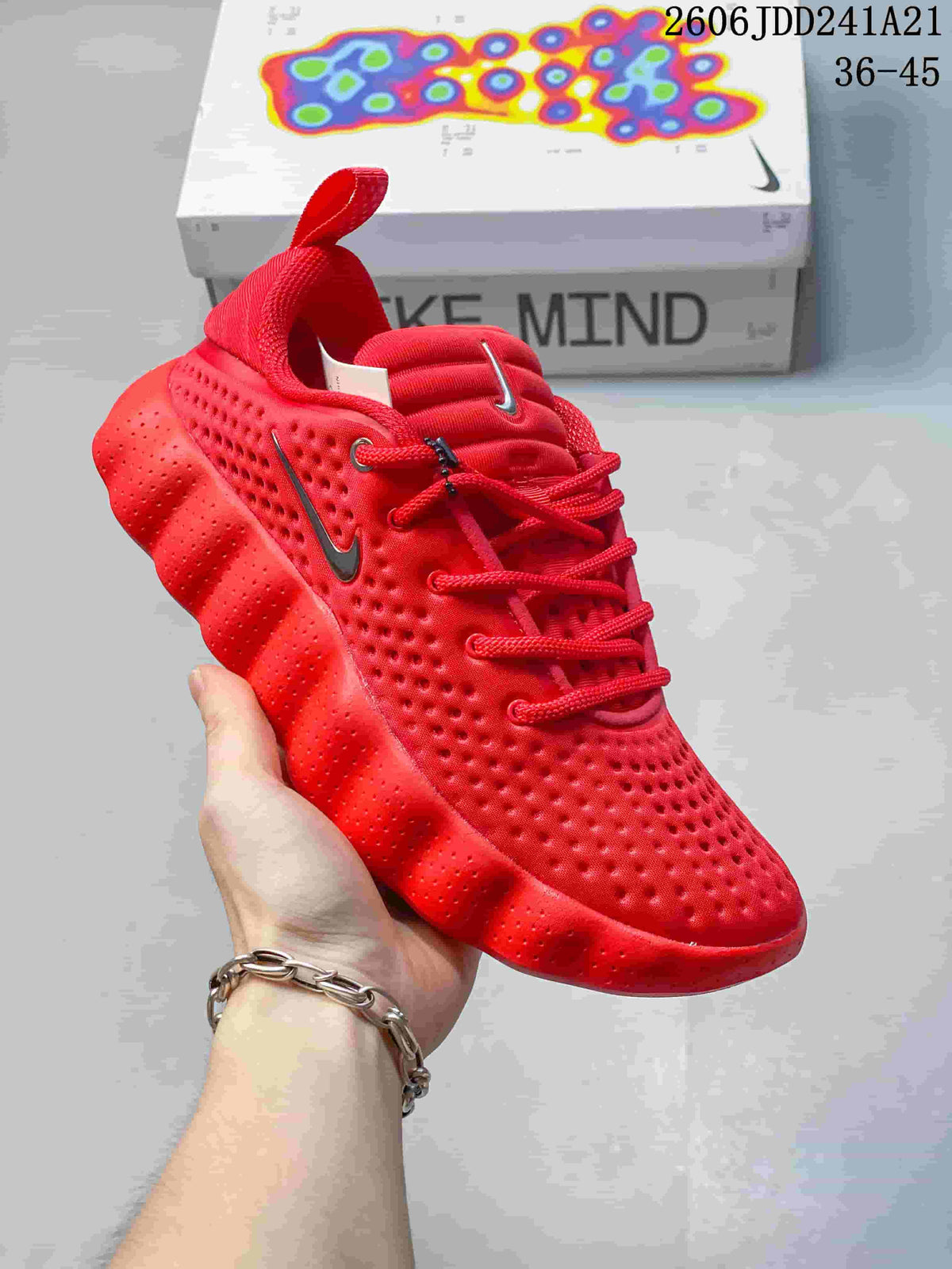 Angled view of the red low-top shoe showing its textured upper and rounded sole pods