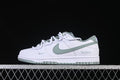 Side view of a white and sage-green Nike SB Dunk Low sneaker with Victory lettering on the heel.