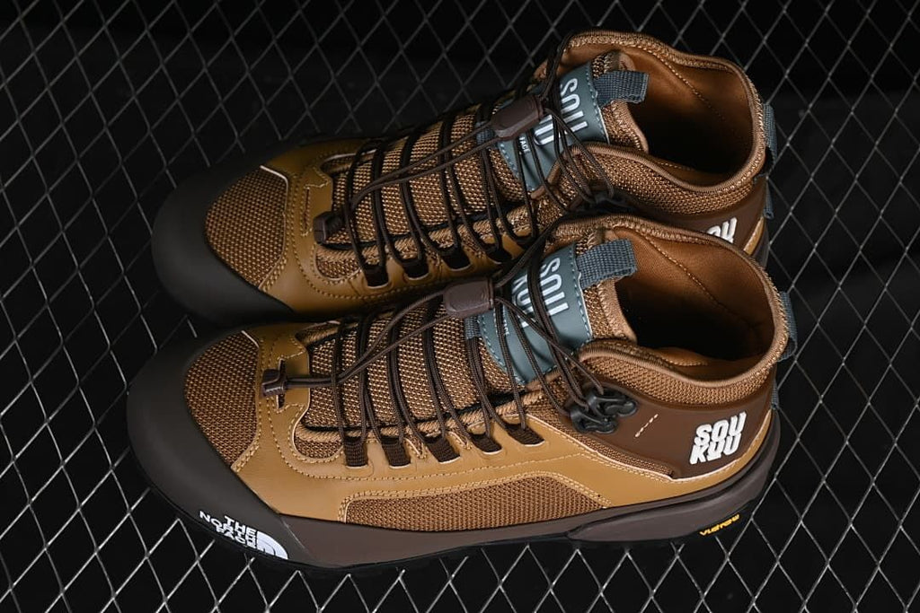 Pair of brown mid hiking shoes photographed from above