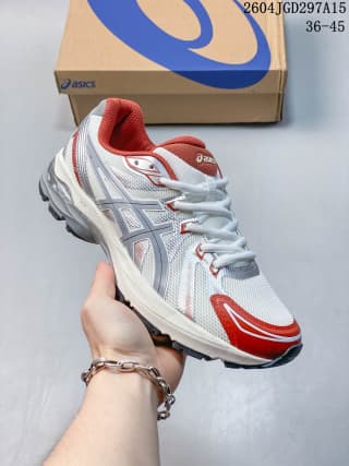 Angled side view showing the white mesh-style upper, red accents, layered ASICS side detailing, and lace-up front.