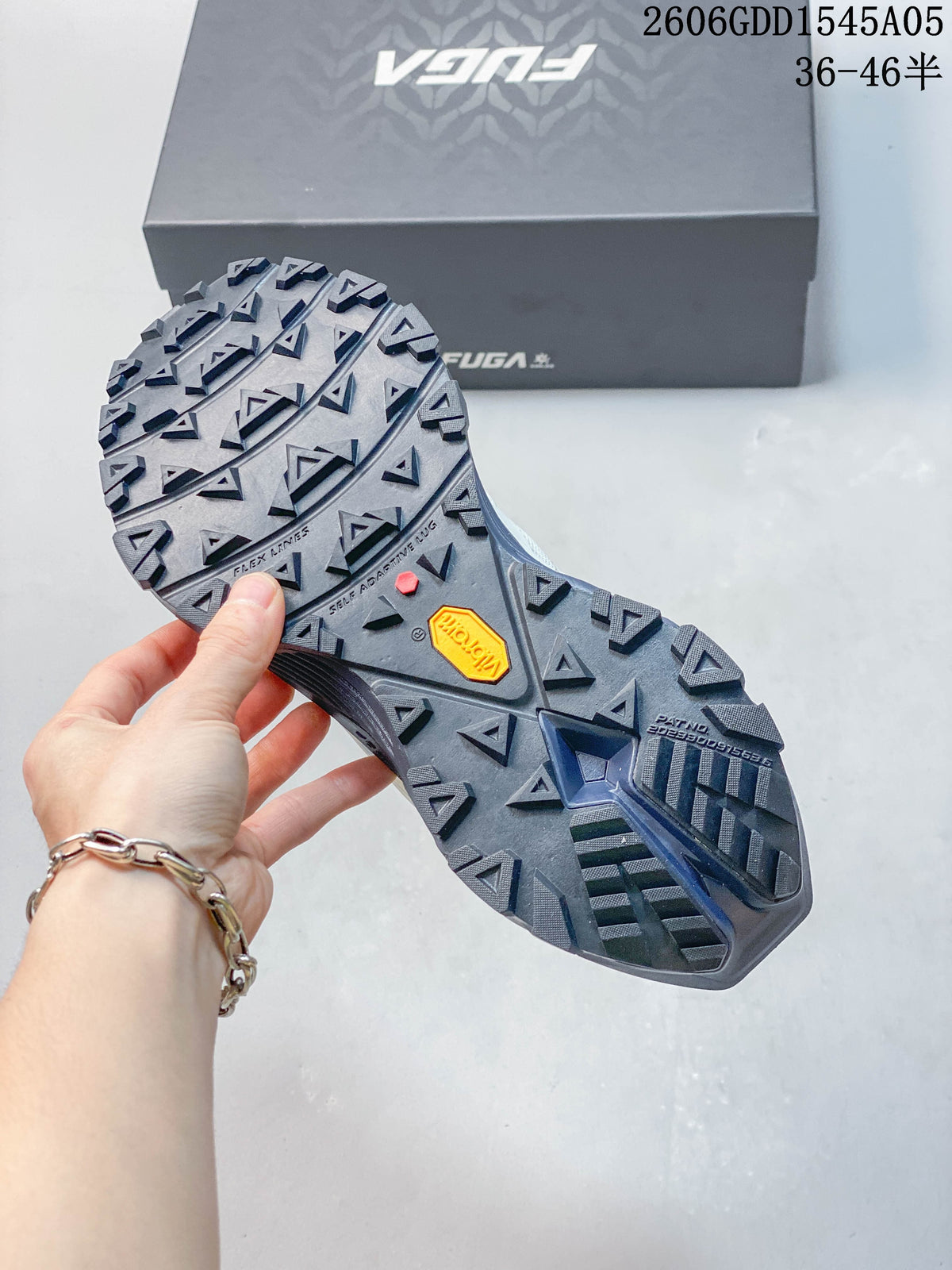 Close-up of the shoe's lugged outsole and visible Vibram mark.