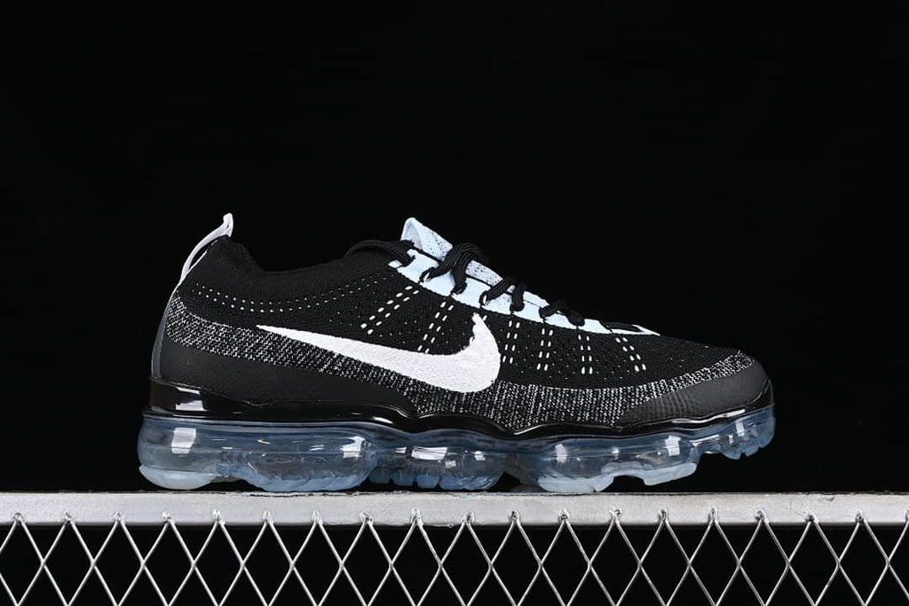 Side profile showing the black and white upper and full-length translucent sole.