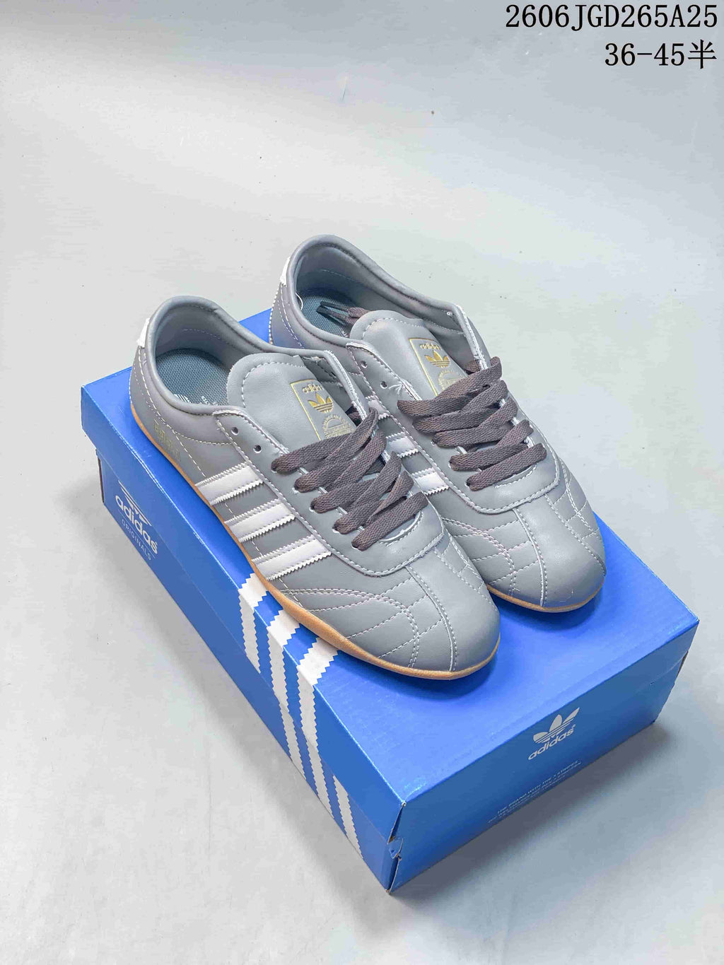 Gray adidas Originals Tokyo low-top sneakers with white side stripes and gum-colored soles