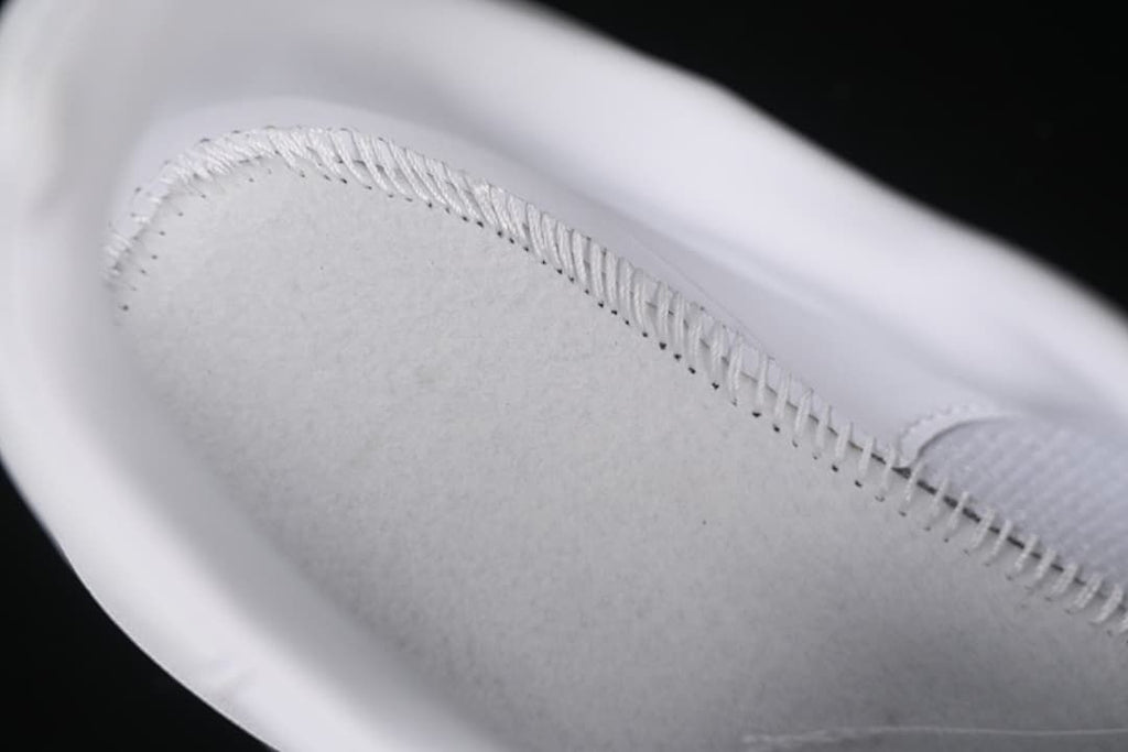 Close-up of interior stitching inside the white sneaker